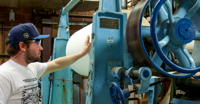 Student working with 网赌平台's paper machine.