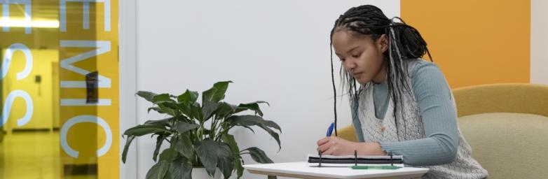 Student seated working at a desk at the Academic Success Center.